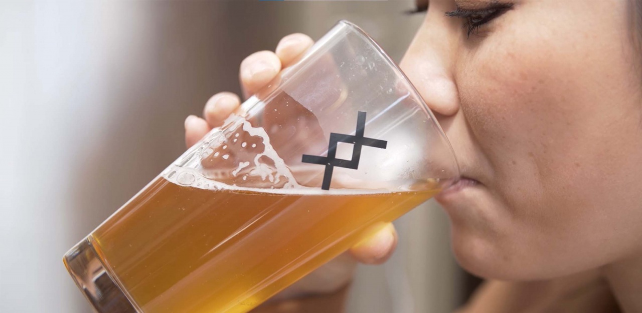 Woman drinking glass of kombucha Woman drinking glass of kombucha