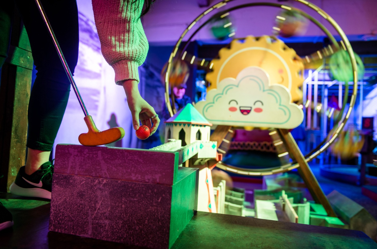 A woman playing mini golf at Holey Moley
