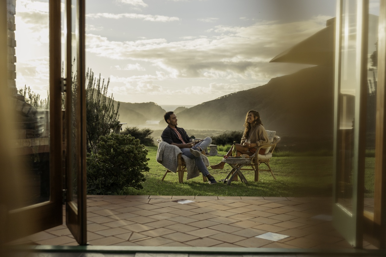 Man and woman at accommodation by the beach.