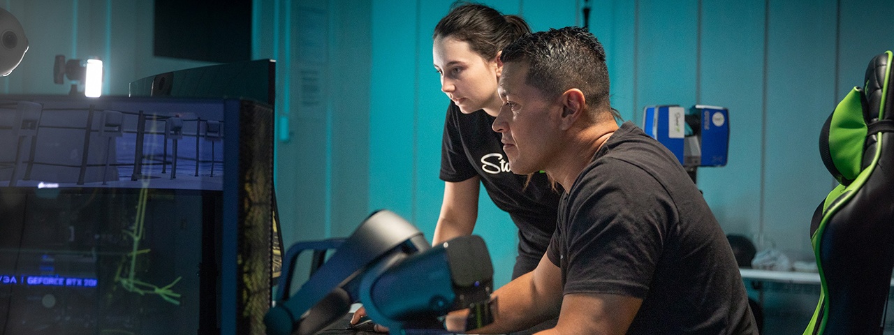 Man and woman talking over a computer