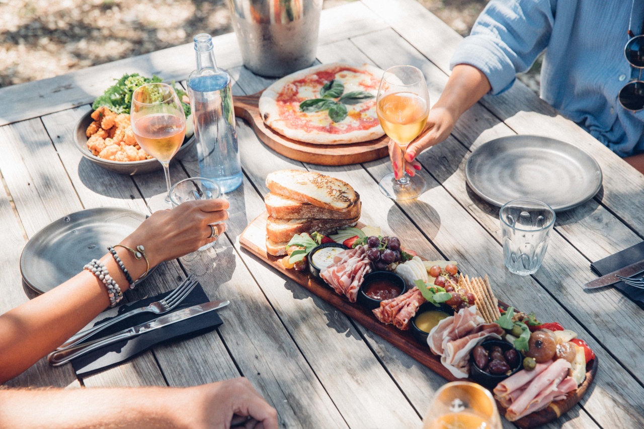 People sharing platters and pizza and drinking on Waiheke Island