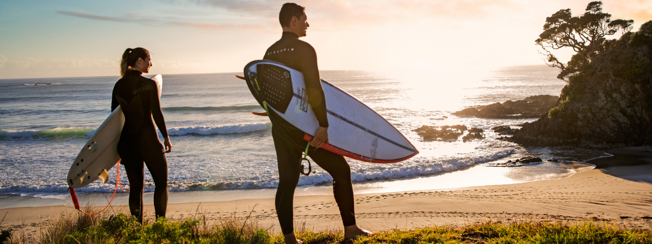 Surfers at Medlands Beach, Great Barrier Island