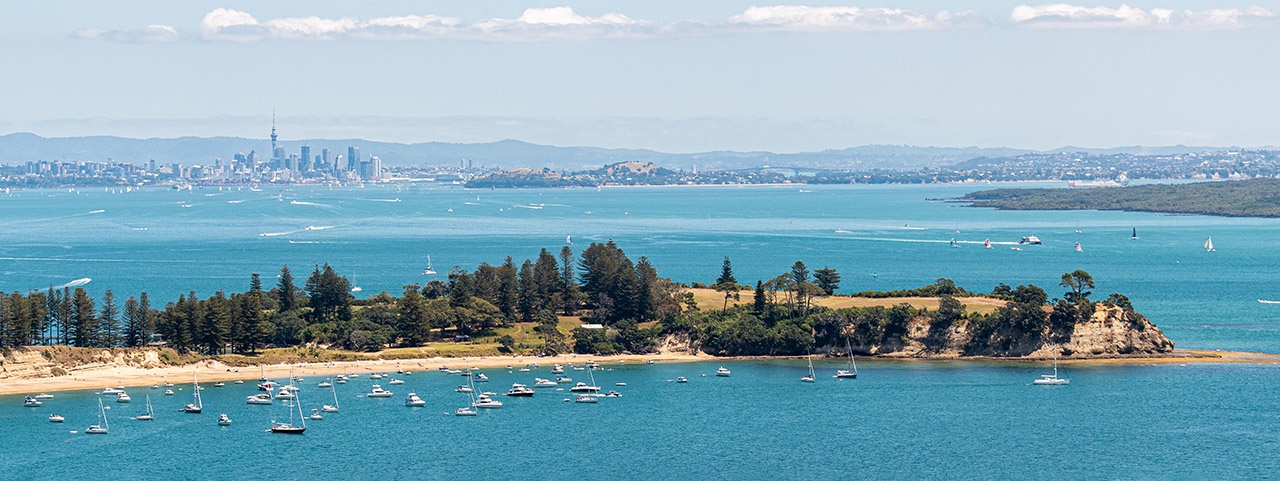 Motuihe Island and city backdrop Motuihe Island with boats in the harbour and Auckland city in the background