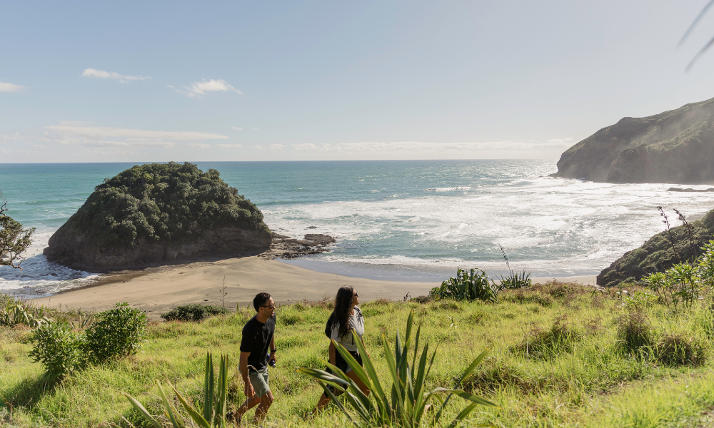 Two people walking along a path in nature