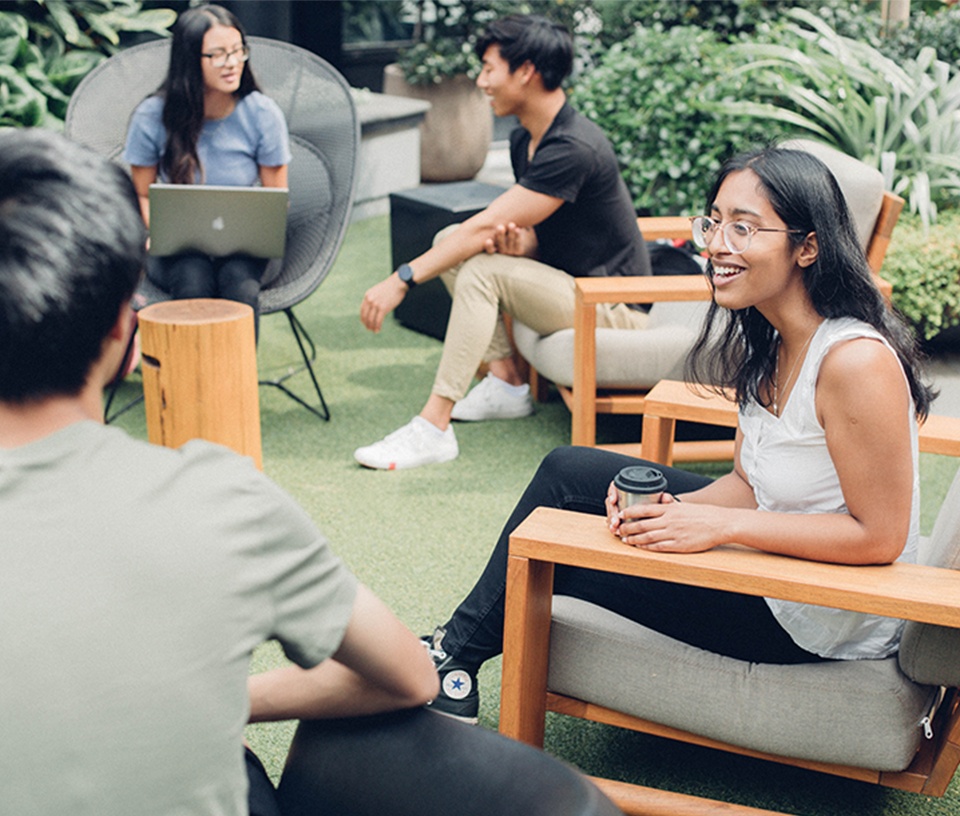 Group of Youth sitting having coffee and chatting