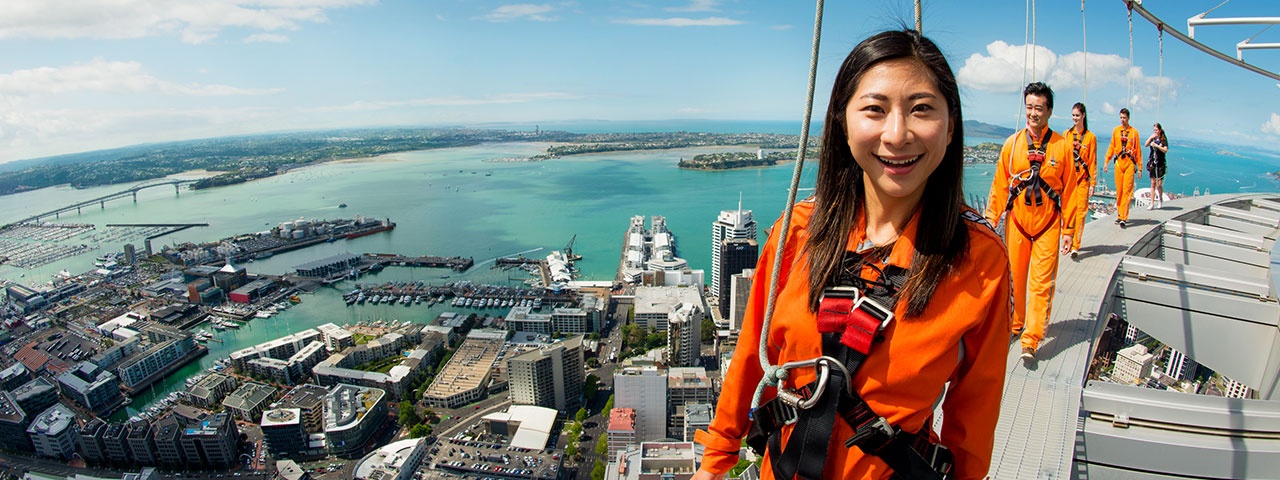 A lady and her friends enjoying an amazing view of Auckland from the SkyWalk
