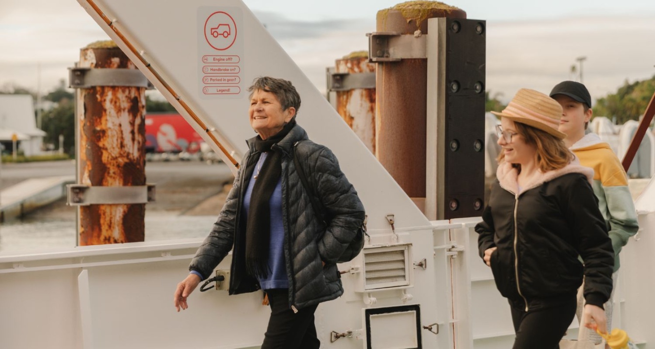 Two people walking on board the SeaLink ferry