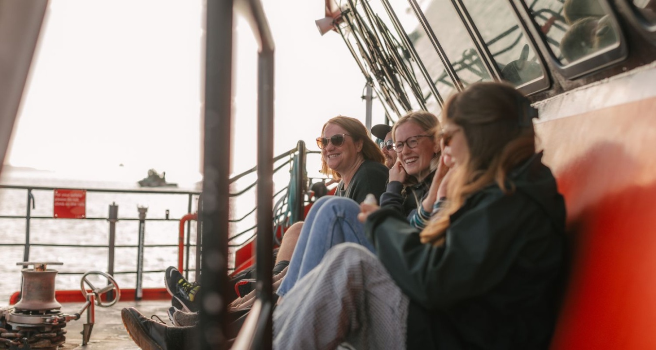 Group of people sitting on deck the SeaLink ferry