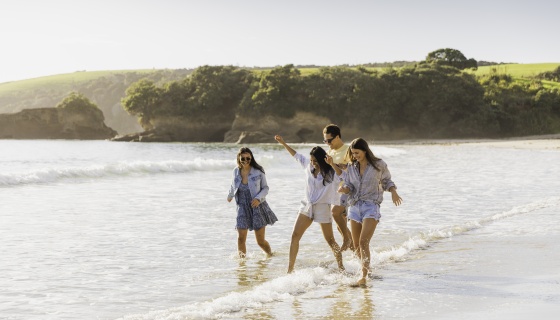 Group of people walking in shallow water