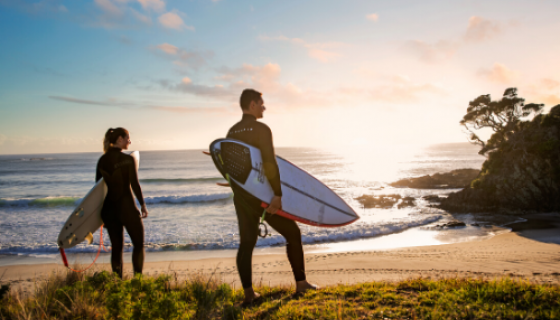 Surfers at Medlands Beach, Great Barrier Island