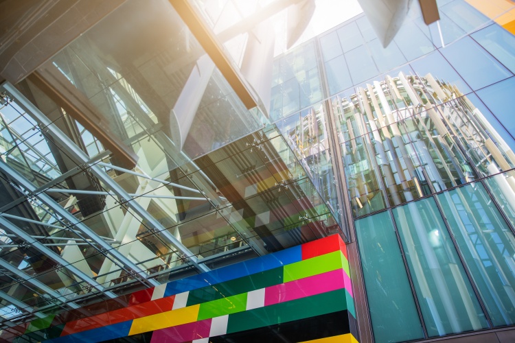 Looking up at a glass building and artwork at Jellicoe Street in Auckland