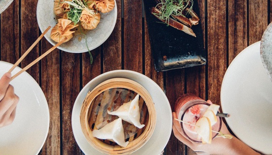 Close up of dumplings and greens at a restaurant